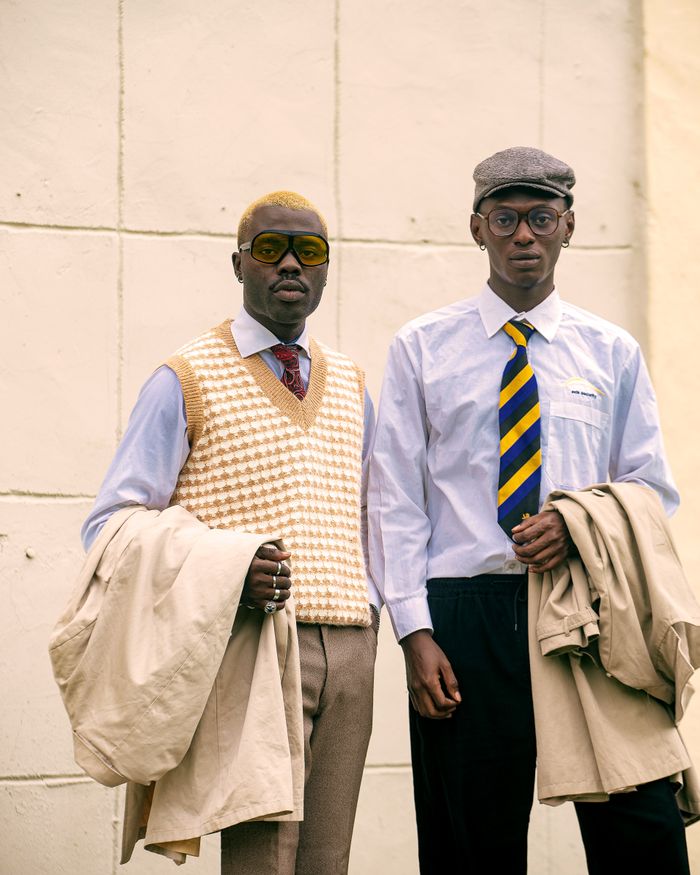 Services-02 Two men pose in vintage style attire, showcasing retro fashion with unique accessories.